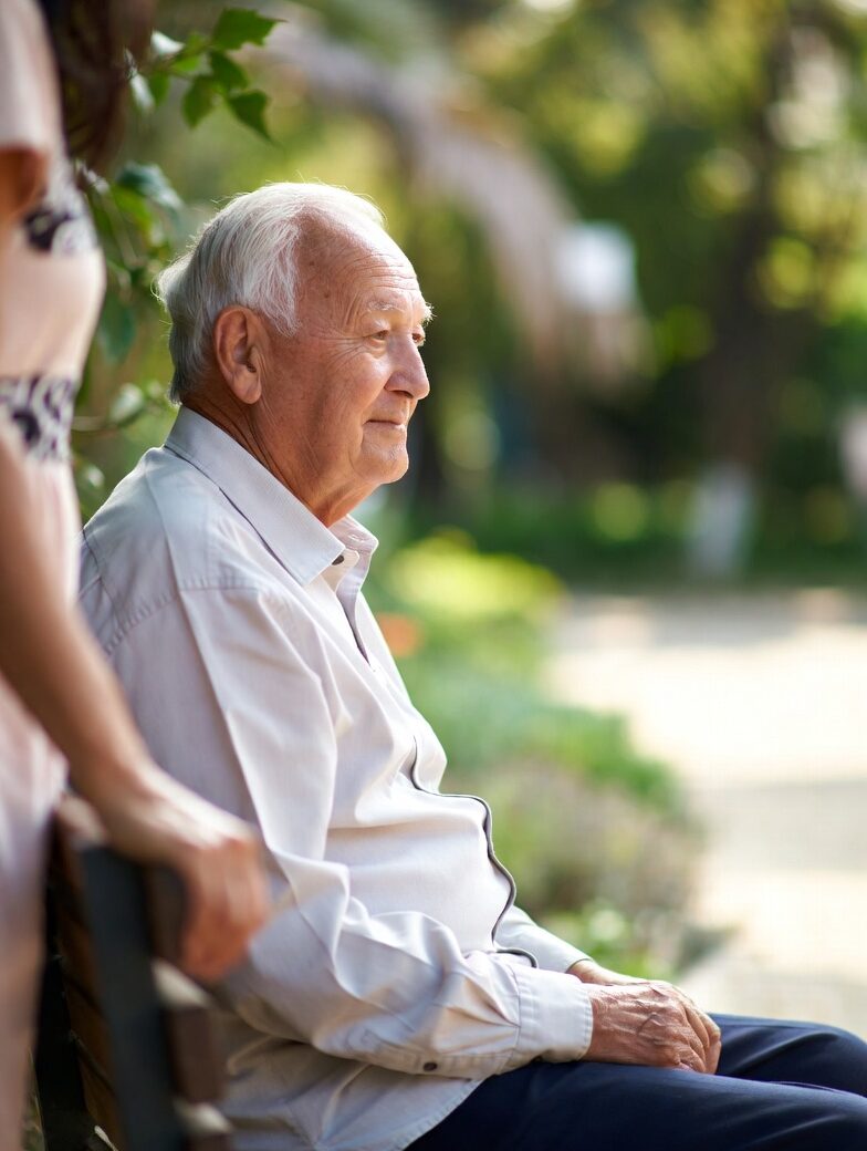 Elderly man enjoying a calm outdoor moment with respite care support.